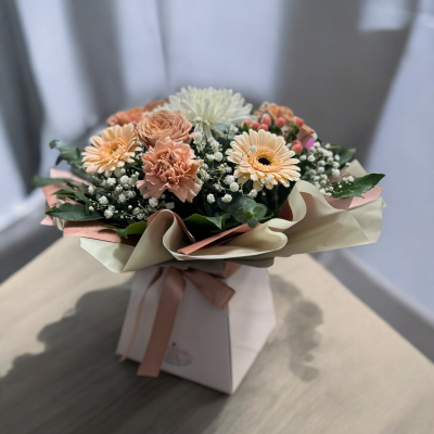 peaches and creams - Peaches and creams is one of our best selling products, Nude, peach and cream flowers brought together and exquisitely gift wrapped, arranged in floral foam for easy care.