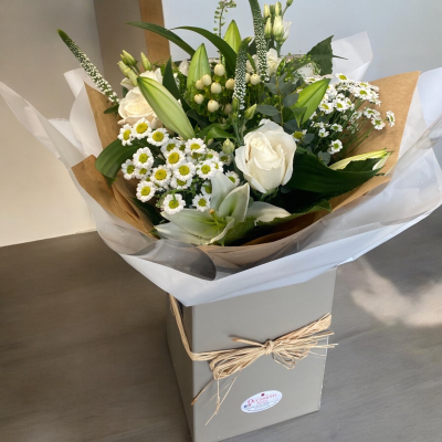 Thinking of You - This product is arranged in a hand-tied style contained in an aqua pack, delivered in a box right to your door with a personal touch. Simply neutral hand-tied.