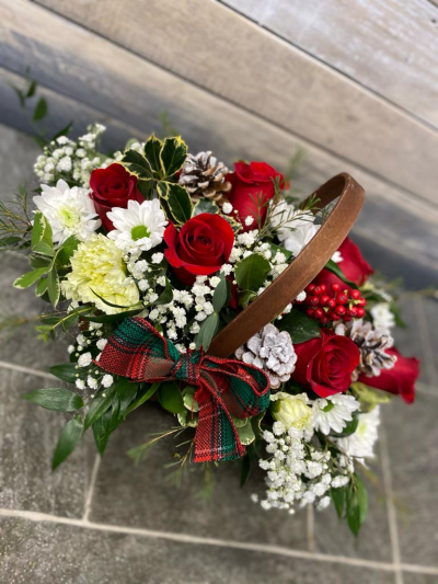 Basket Of Joy - This collection of beautiful flowers and seasonal foliage are expertly arranged in a beautiful basket for the perfect Christmas gift.